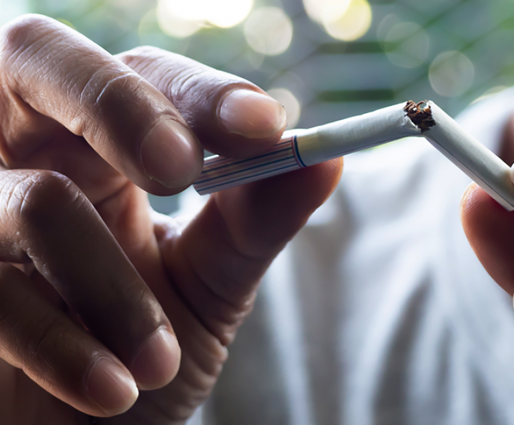 Person breaking cigarette